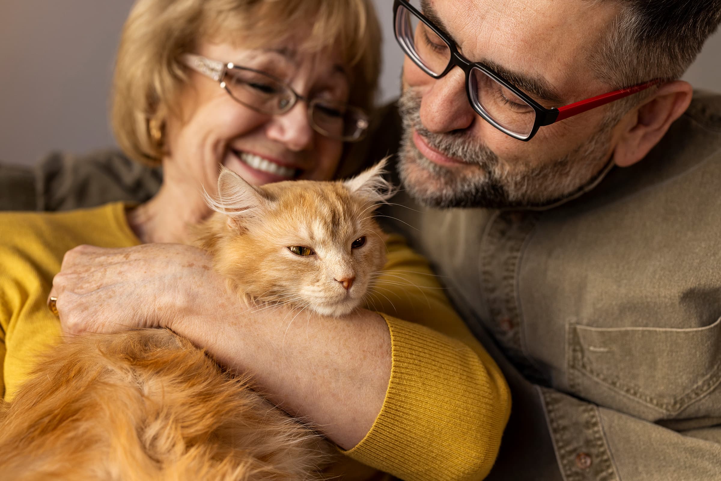 A couple holding their adopted cat